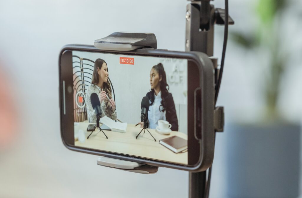 two girls recording a viral video for their podcast episode